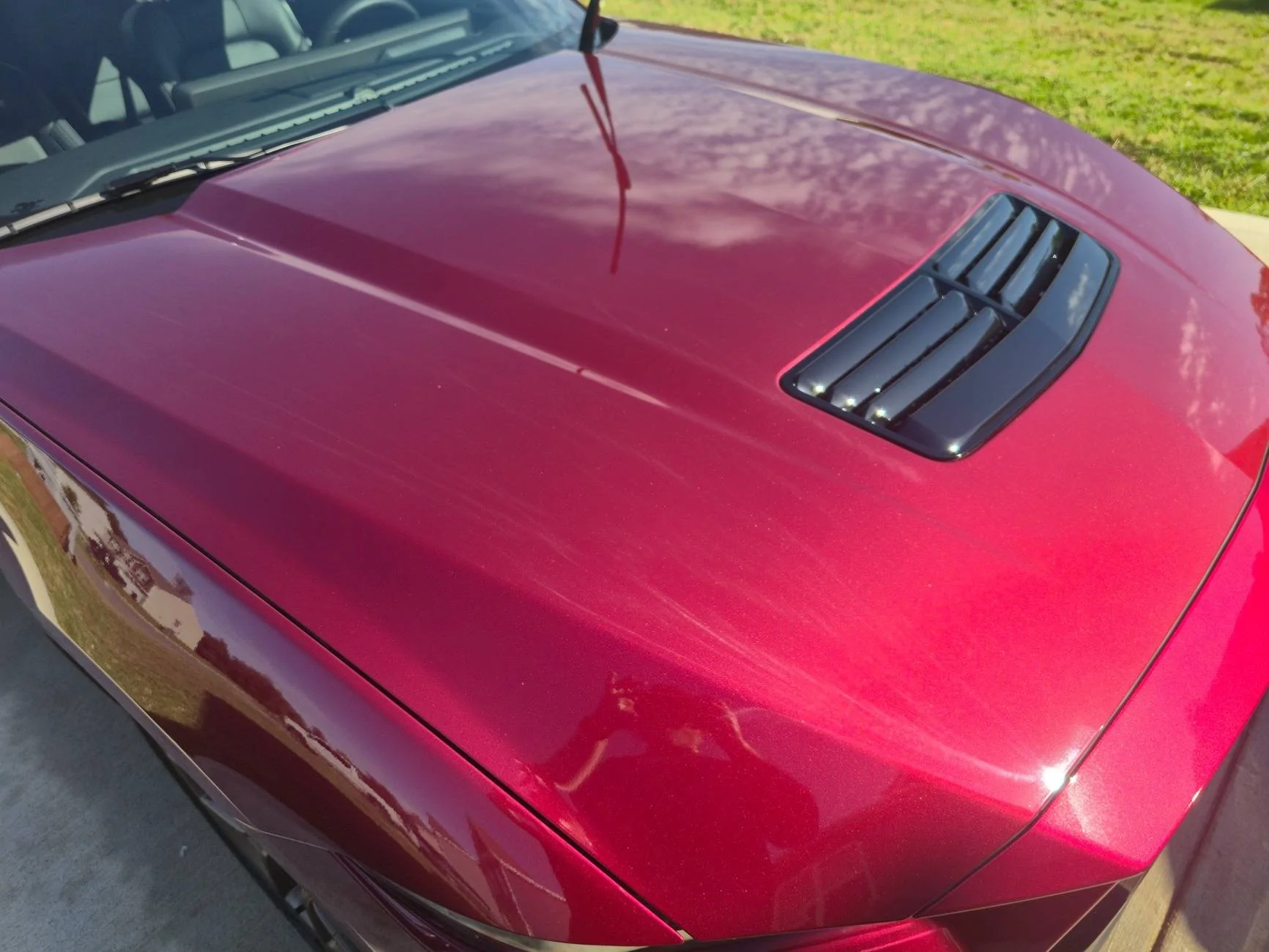 S650 Mustang Dealer attempted to fix some paint defects on the hood of our new S650 but now there appears to be streaks in the clear coat. What caused this? 20250518_092702